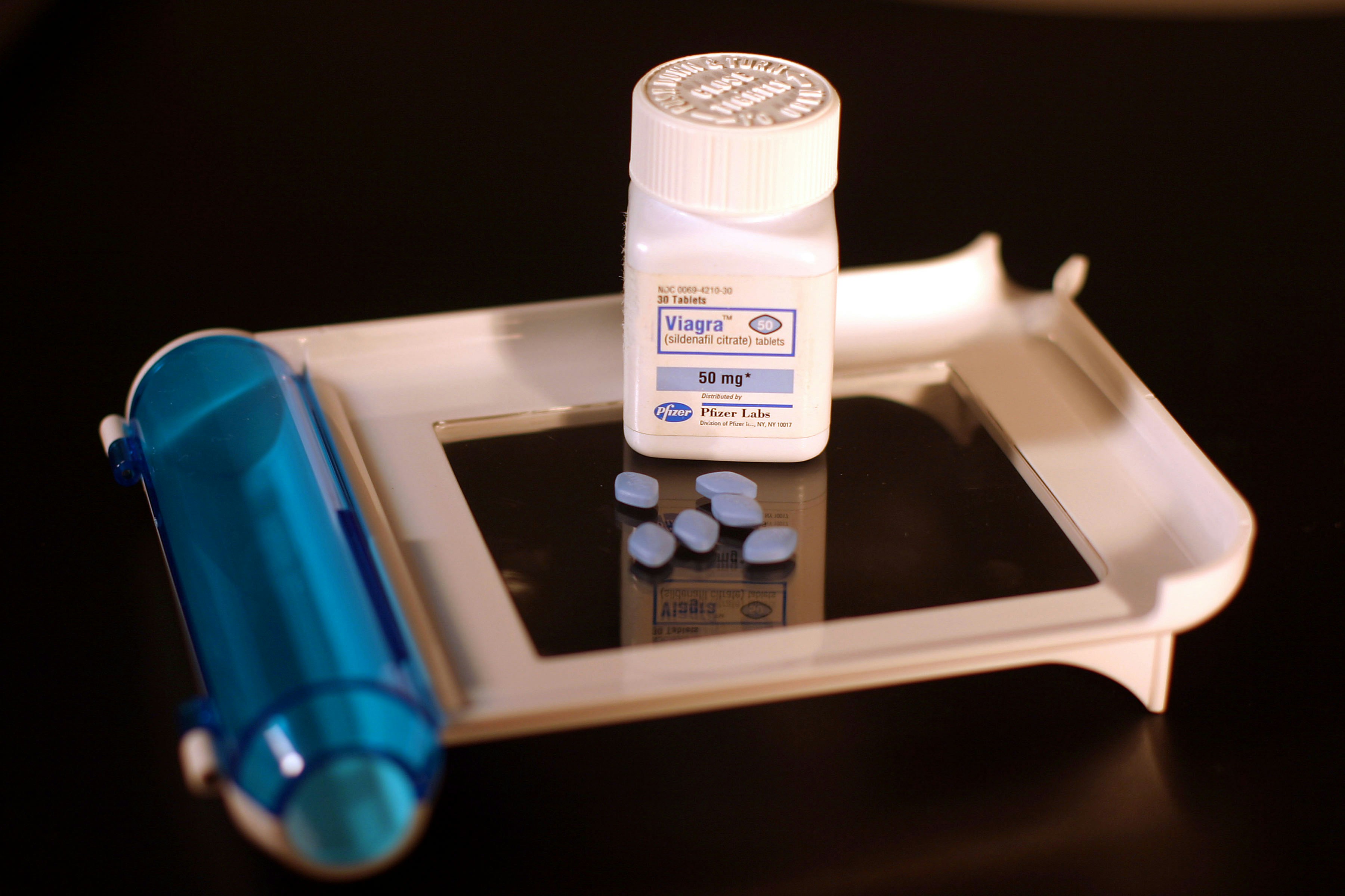 a white device with a blue tube